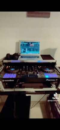 a dj set with a laptop on top of it