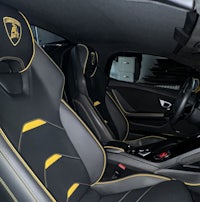 the interior of a black and yellow sports car