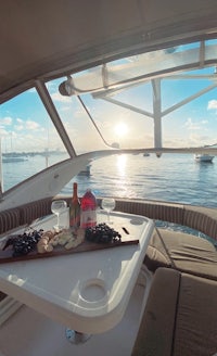 a boat with a table and wine on the deck