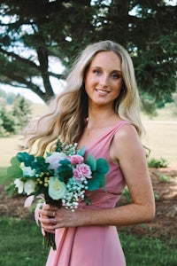 a bride in a pink dress holding a bouquet