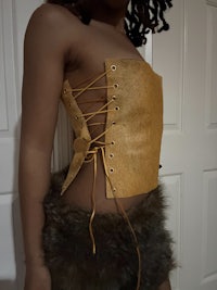 a woman wearing a gold corset