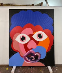 a painting with a blue and red face on it