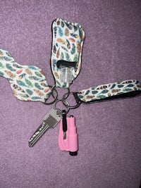 a key holder with a pink key and a pink key