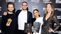 a group of people posing for a photo with their awards