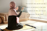 a woman wearing a hijab praying on the floor