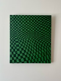 a green and black checkered painting hanging on a wall