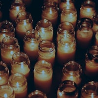 a group of candles lit in a dark room