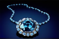 a necklace with a blue topaz and diamonds