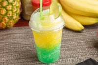 a green and yellow drink with pineapples and bananas