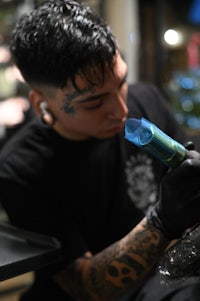 a man is getting a tattoo at a tattoo shop