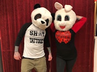 a man and a woman wearing panda mascot costumes