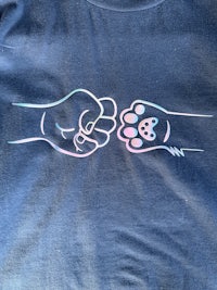 a t - shirt with an image of a cat and a paw