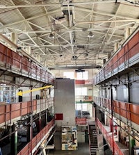 the inside of a factory with a lot of stairs
