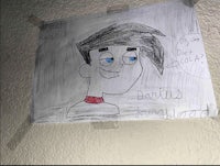 a drawing of a boy hanging on a wall
