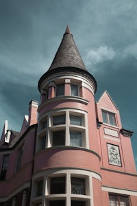 a pink building with a turret