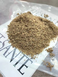 a pile of brown powder on top of a plastic bag