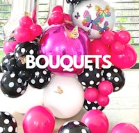 a bouquet of balloons with polka dots and black and white balloons