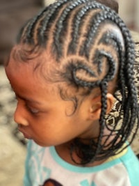 a little girl with braids in her hair