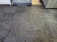 a grey tiled floor in a kitchen