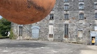 a large orange ball in front of a building