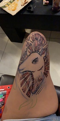 a drawing of a deer on a person's thigh