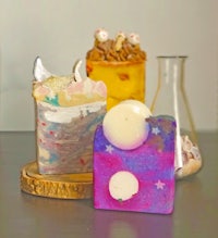 three soaps sitting on top of a wooden table