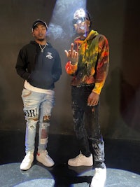 two men standing next to each other with smoke coming out of their mouths