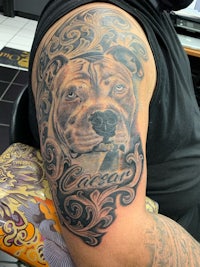 a tattoo of a dog on a man's arm