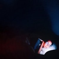 a woman sleeping in a dark room