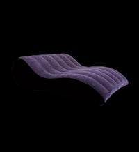 a purple chaise lounge on a black background
