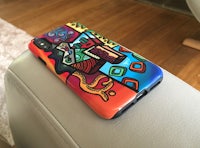 a colorful phone case sitting on a chair