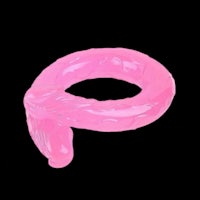 a pink plastic ring on a black background