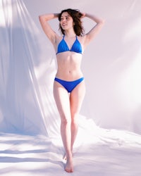a woman in a blue bikini posing for a photo