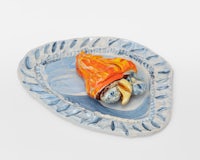 a blue and orange plate with a piece of food on it