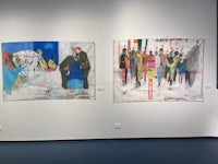 a group of paintings on display in an art gallery