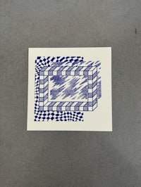 a blue and white drawing on a piece of paper