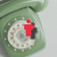 a green telephone with a red icon on it