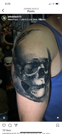 a man with a skull tattoo on his arm