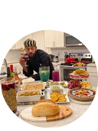 a man standing in front of a kitchen full of food