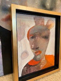 a painting of a woman in a gold frame