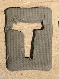 a piece of clay with the letter t on it