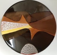 a brown and brown plate with a design on it