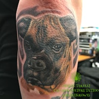 a tattoo of a boxer dog on a man's arm