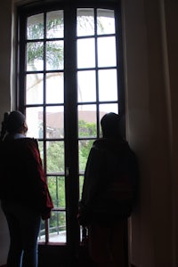 two people looking out of a window