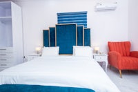 a bed in a bedroom with blue and orange accents