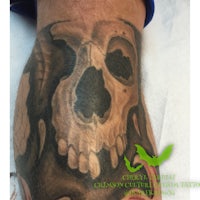 a tattoo of a skull on a man's forearm