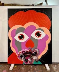 a large painting with a face on it
