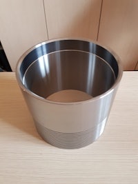 a stainless steel bowl sitting on top of a wooden table