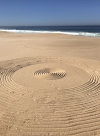 a spiral in the sand on a beach