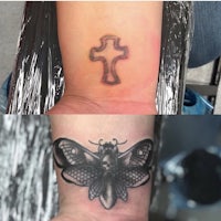 a tattoo of a cross and a moth on a wrist